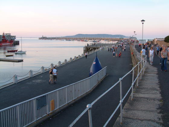A long harbour-side path leading to a pier